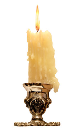 burning old candle vintage bronze candlestick. Isolated On a White Background.の写真素材