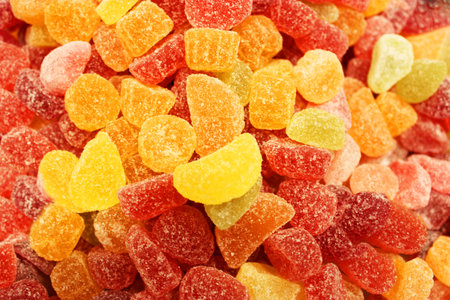 Colorful texture using as background. A lot of sweets. Background 3d rendering illustration. Orange and black multiple jelly candies in powdered sugar. Confectionery wallpaper concept. Copy space. Shallow focus. High quality photoの写真素材