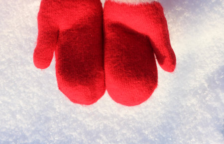 Red mittens lie on the snow. mitten lying on the snow in winter. Holiday Decorations Christmas and New Year Traditions Panoramic Banner Free Space Text Top View Flst lay. Christmas winter backgroundの写真素材