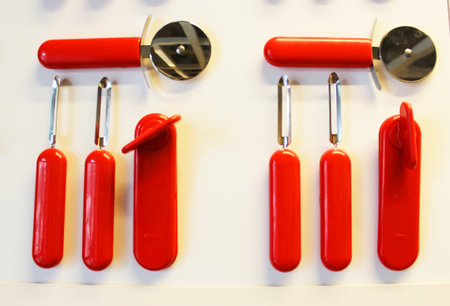 potato peeler, whisk, electronic kitchen clock, timer, pizza knife on a white background with copy space. set of plastic cutlery on white flat lay. and a place for food objects. plastic kitchen utensils of different colors. High quality photoの写真素材