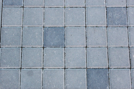 Concrete or cobble gray square pavement slabs or stones for floor, wall or path. Traditional fence,...