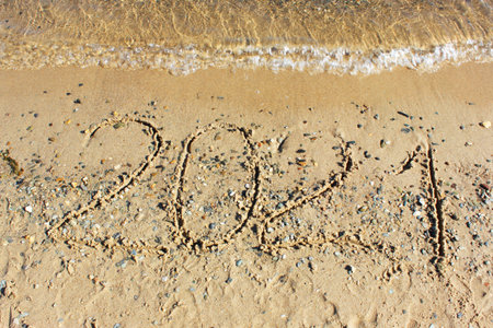 New Year 2022. Message written on the background of a sandy beach. hello concept for the upcoming...