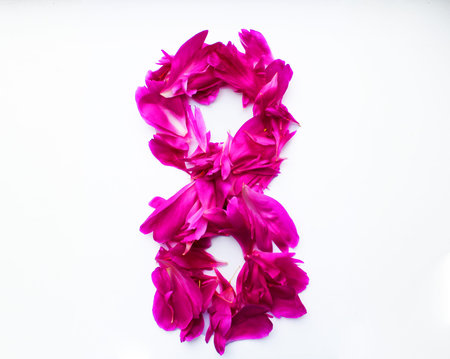 March 8 from flower petals on a white background