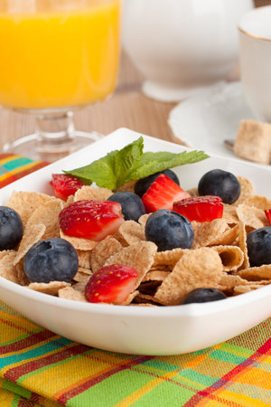 delicious breakfast with orange juice, coffee and muesli with berries