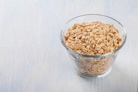 oatmeal in a bowl of glass on a blue background
