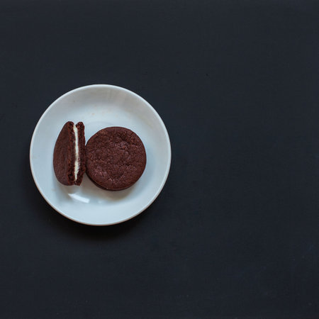 Oreo cookies on a black background with coffeeの写真素材