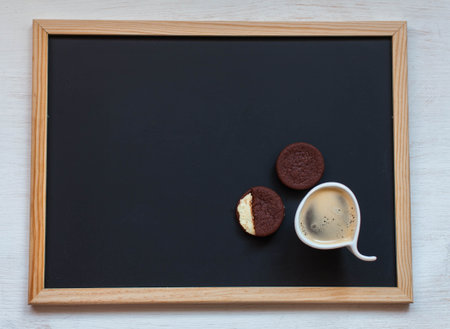 Oreo cookies on a black background with coffeeの写真素材