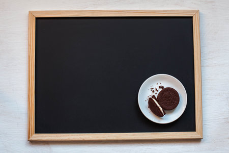Oreo cookies on a black background with coffeeの写真素材