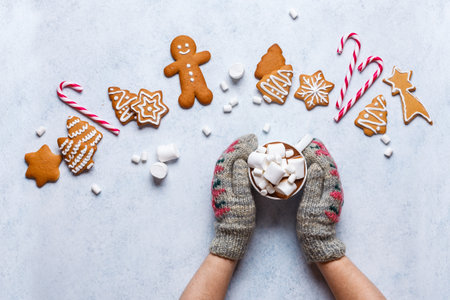 Christmas ginger cookies on a gray-blue background, horizontal, new Year, flat lay, copyspace, hands in mittensの写真素材
