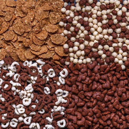 Dry breakfast, granola, muesli on a black background square top view copyspace flat lay