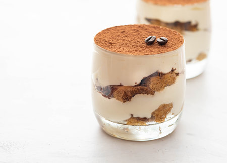 Classic tiramisu in a glass on a white background. Copy space.の写真素材