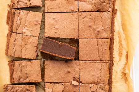 Homemade brownies with dark chocolate on a paper background. Overhead shot.の写真素材