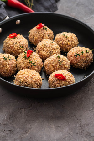 Raw meatballs in a pan on black background. Copy space.の写真素材