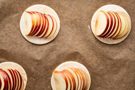 Cooking process of galetta, biscuit with apples on paper background. Apple pie with cinnamon.の写真素材