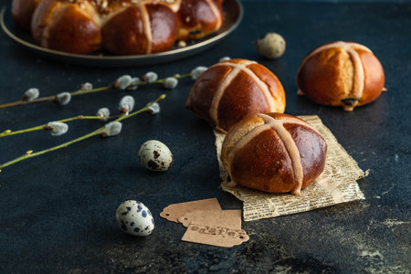 Traditional Easter cross buns on easter background.
