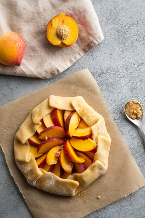 Appetite summer peach galeta on white table with copy space. summer open tart photo for cook book or...