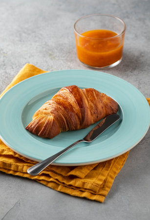Delicious breakfast with fresh croissants and coffee served with butter and honey.の写真素材