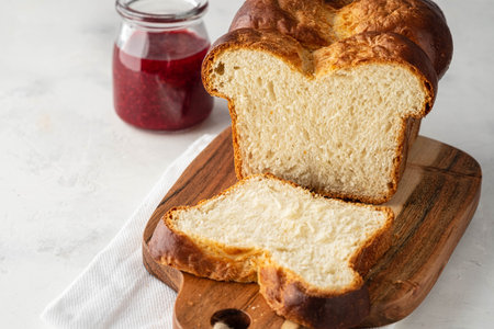Delicious homemade organic fresh brioche bread on rustic table. Copy space.