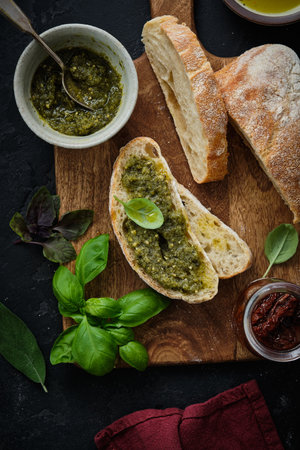Mediterranean snacks set. Olives, oil, herbs and sliced ciabatta bread. Top view.の写真素材
