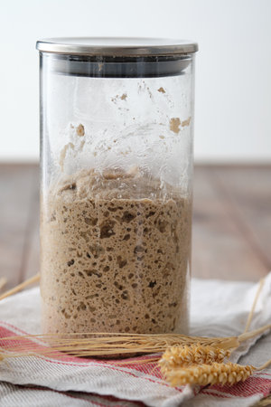 Active rye sourdough starter in a jar. Copy space.の写真素材