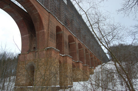 Large brick bridge under restoration in winterの写真素材