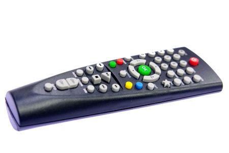 one black, dark gray TV remote control channel switch, green OK button, on a light, white background...