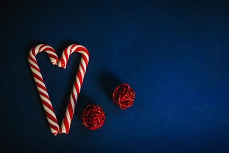lollipops in the shape of a heart for Valentine's day on a blue background.love