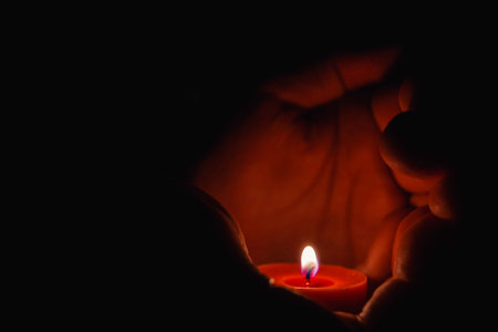 prayer - candle in hands. grief, sadness sorrowの写真素材