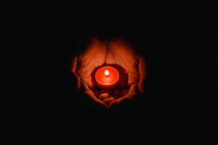 prayer - candle in hands. grief, sadness sorrowの写真素材