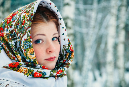 girl - Slavic appearance wrapped in a scarf in winter.