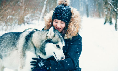gentle hugs. dog and cute girlの写真素材