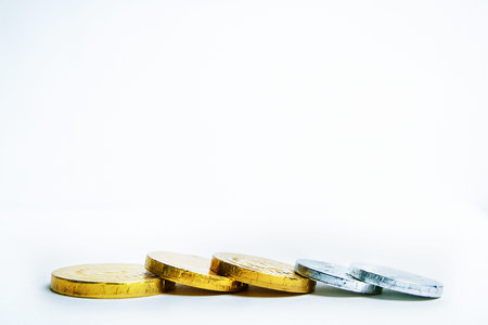 Gold and silver chocolate coins in wrappers.