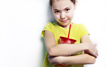 the girl in the yellow t-shirt with the big red glass.の写真素材