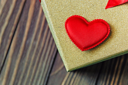 gift box and heart on wooden background.の写真素材