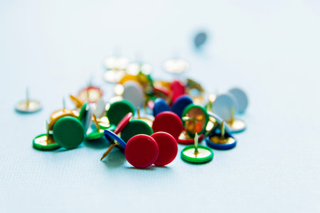 multicolored Pushpins, office theme on light background