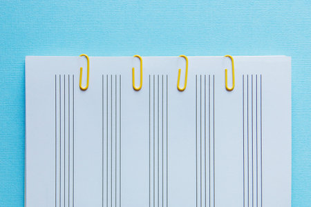 sheet Notepad and yellow clips on a blue background.