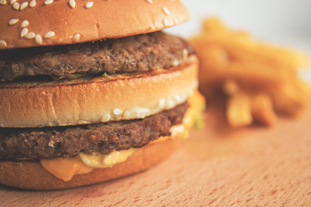 Burger and French fries on a wooden Board.の写真素材