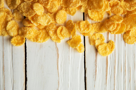 Golden crisp cereal for Breakfast on a white wooden background.
