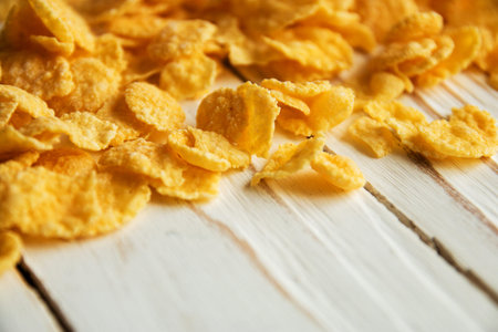 Golden crisp cereal for Breakfast on a white wooden background.