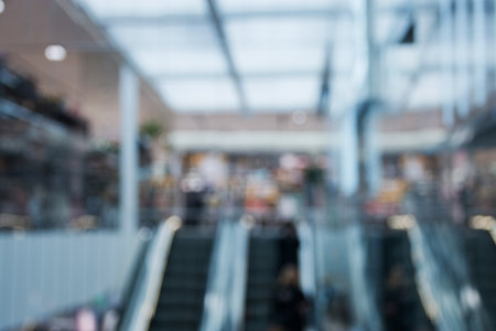 blurred background of people climbing the escalator in the store.の写真素材