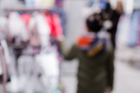 blured background of girl in store choosing clothes for yourself.の写真素材