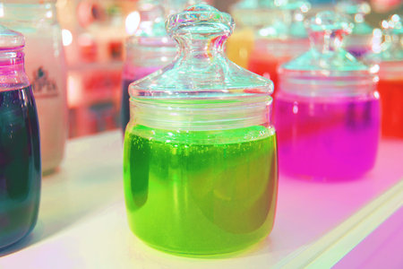 glass jars of bright jam and jelly for tasting on display.の写真素材