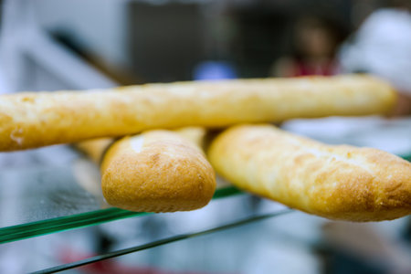 Bread baguettes in the baking shop close up.の写真素材