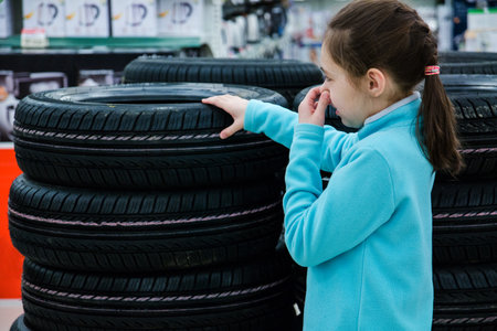 the girl closes her nose from the unpleasant smell of rubberの写真素材