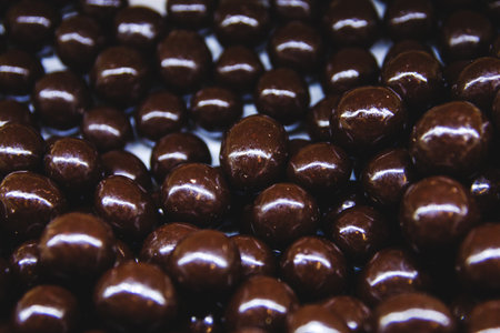 Almonds in chocolate on the shop window close - up view from above.の写真素材