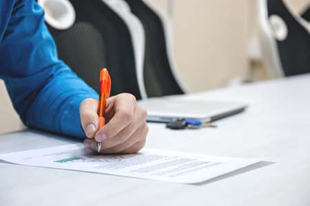 Analyzing charts and reports.The person checks the data in the report. Work concept. Work in the...