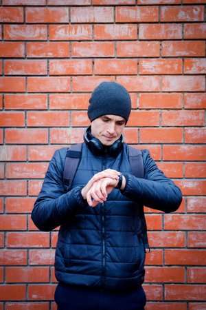 portrait of handsome man looking at his watch. Time concept.の写真素材