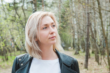 Portrait of blonde young girl in the forest.の写真素材