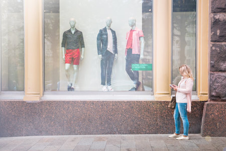 Moscow, Russia, May 22. 2018: the girl standing at the shop window of the famous brand.のeditorial素材