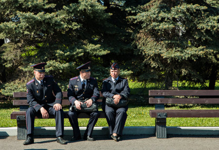 Moscow Russia, May 9, 2018: police officers sitting on a bench in sunny dayのeditorial素材